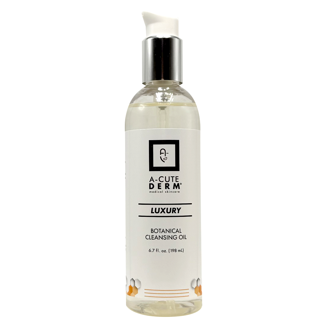 A bottle of A-Cute Derm Luxury Botanical Cleansing Oil on a solid white background. The bottle is clear, showing the pale yellow oil inside, with a white label and a silver pump dispenser.